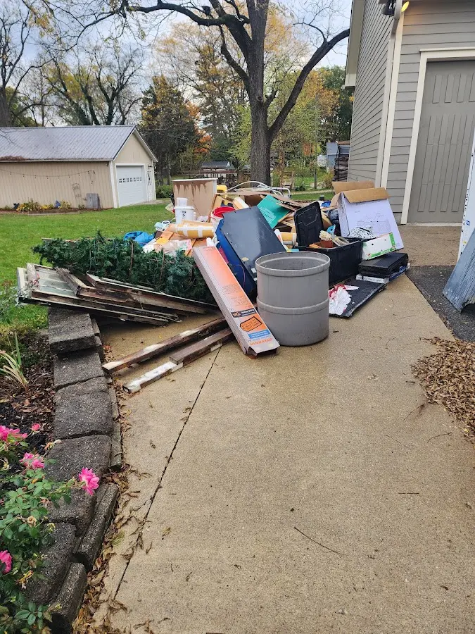Dumpster being loaded with debris for Roofing Dumpster Rental in Lindenhurst
